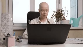 cancer patient smiling while studying or working online, representation of diversity and resilience in digital workspace environment - Powered by Shutterstock - Get 15% off with code: PIKWIZARD15