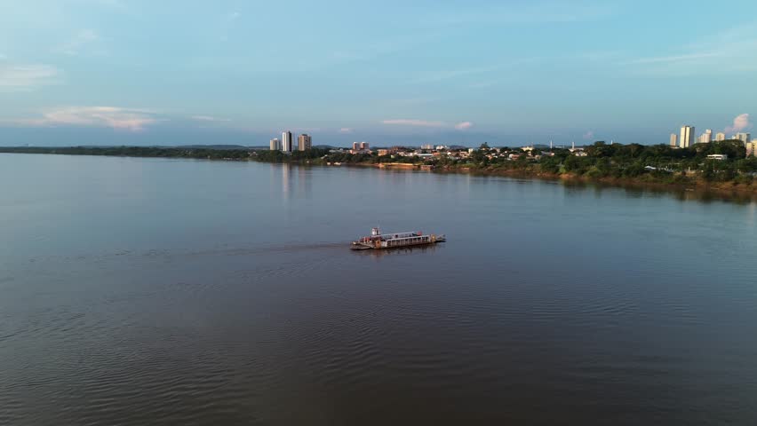 Golden hour aerial view of the Tocantins River landscape with a ferry crossing near Imperatriz, Maranhao