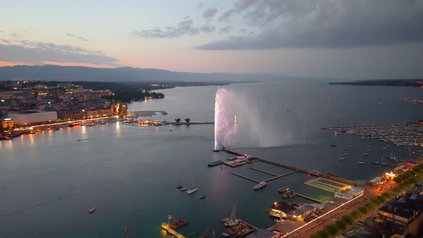 Aerial view of Geneva, set against a mesmerizing twilight sky, captivates viewers. Switzerland