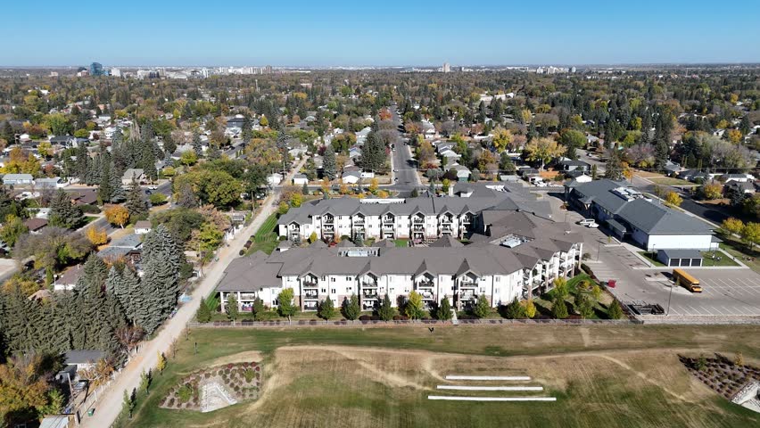 Drone footage of Adelaide Churchill Saskatoon highlighting residential streets, green spaces, and family homes in 4K.