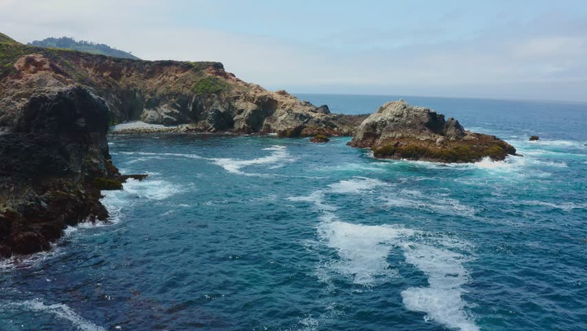 Big Sur California USA video footage of rugged Pacific coastline along Highway 1 with dramatic rocky cliffs, crashing ocean waves, and scenic seascape view of the wild California coast