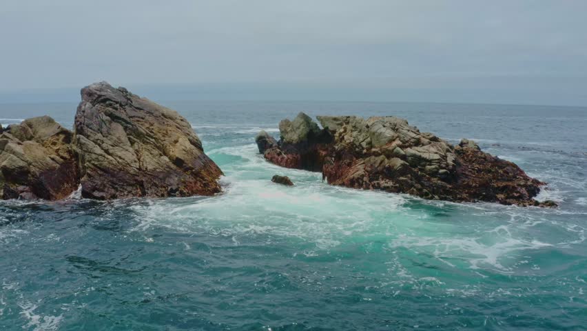 Big Sur California USA video footage of rugged Pacific coastline along Highway 1 with dramatic rocky cliffs, crashing ocean waves, and scenic seascape view of the wild California coast