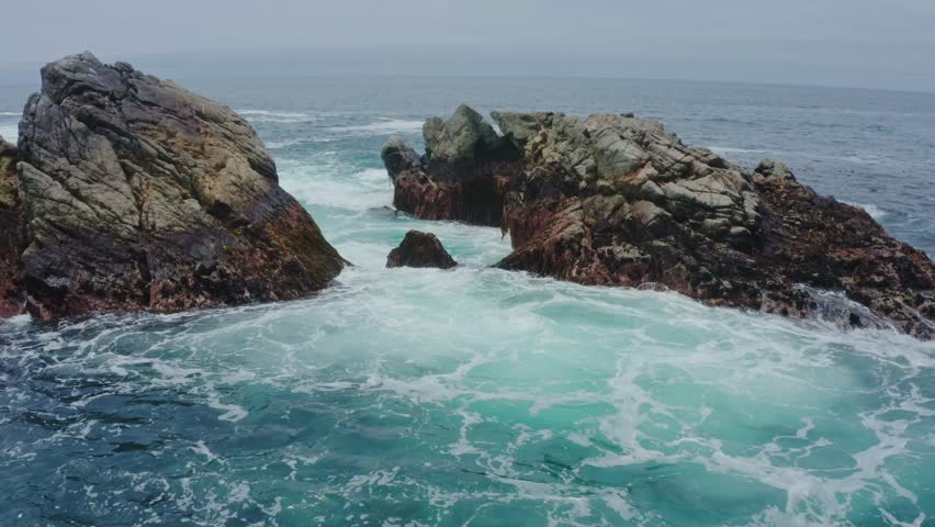 Big Sur California USA video footage of rugged Pacific coastline along Highway 1 with dramatic rocky cliffs, crashing ocean waves, and scenic seascape view of the wild California coast