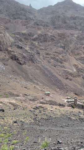 Rocky mountains beneath soft clouds in calm, peaceful weather