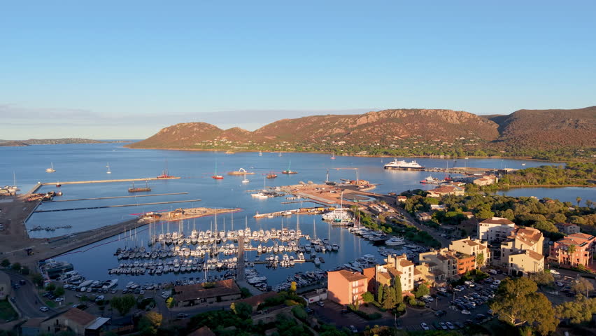 scenic aerial perspective of calm coastal town featuring bright rooftops and gentle bay waters. Porto-Vecchio. France