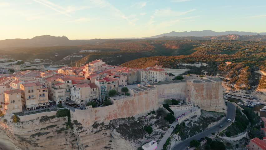 Aerial view of coastal sunset City, peaceful mediterranean coastal community with terracotta roofs during sunset. Bonifacio. France
