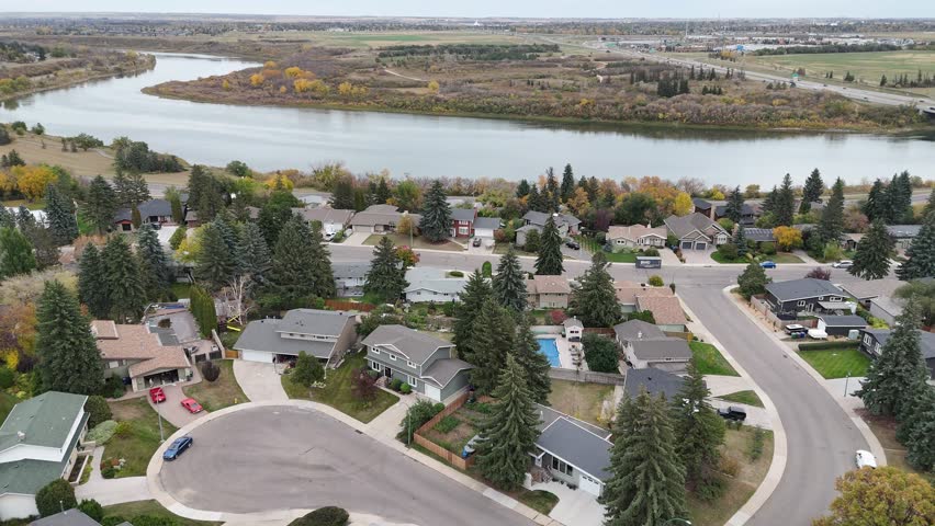 Aerial video of River Heights Saskatoon in fall, showcasing colorful trees, homes, and river views captured in crisp 4K.