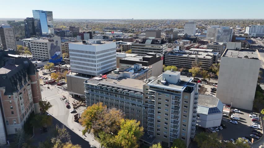 Aerial video of Downtown Saskatoon in fall showing colorful trees, river views, and skyline landmarks in crisp 4K.