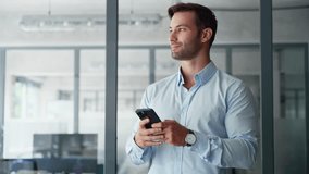 Smiling European or Latin hispanic businessman holding smartphone telephone gadget in office. Middle aged male man trader manager using cell phone mobile tech app for trading. Technology for business - Powered by Shutterstock - Get 15% off with code: PIKWIZARD15