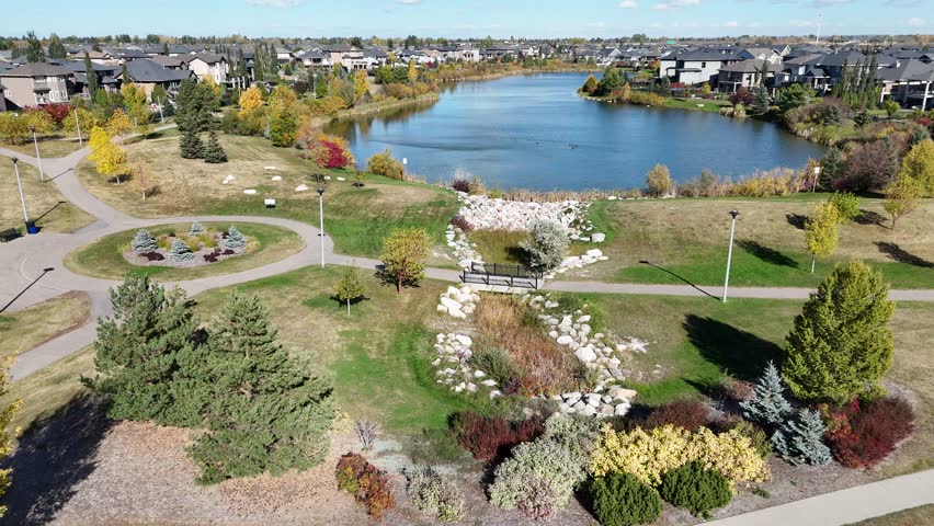 Aerial video of Stonebridge Saskatoon in fall showing colorful trees, parks, and residential areas in crisp 4K.