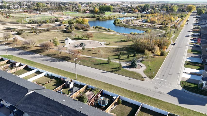 Aerial video of Warman Saskatchewan in fall, showing colorful trees, parks, and residential neighborhoods in crisp 4K.