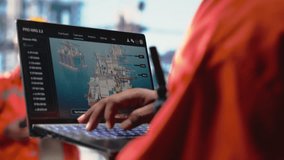 Close up of offshore platform worker using AI on laptop to refine operational efficiency. Engineer using artificial intelligence deep learning to monitor drilling rig production activities, camera B - Powered by Shutterstock - Get 15% off with code: PIKWIZARD15