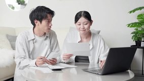 Asian couple checking shopping receipt - Powered by Shutterstock - Get 15% off with code: PIKWIZARD15