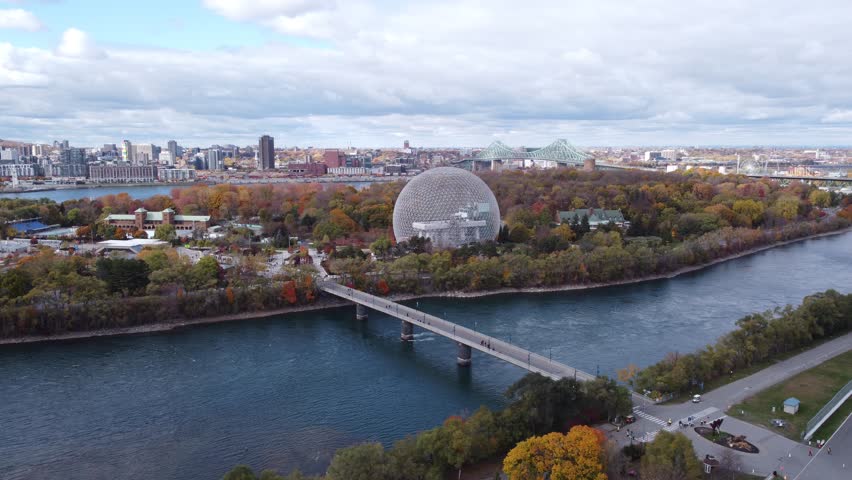 Aerial footage above "La Biosphere" and "Parc Jean-Drapeau" with Old Port of Montreal as background