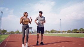 Diverse young man and woman athletes exercising together at stadium. Attractive sportswoman and male trainer warming up and working out, prepare for an upcoming competition during training session - Powered by Shutterstock - Get 15% off with code: PIKWIZARD15