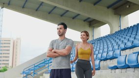 Portrait of Diverse young man and woman exercising together at stadium. Attractive sportswoman and male athlete trainer warming up and working out, prepare for competition then looking at camera. - Powered by Shutterstock - Get 15% off with code: PIKWIZARD15
