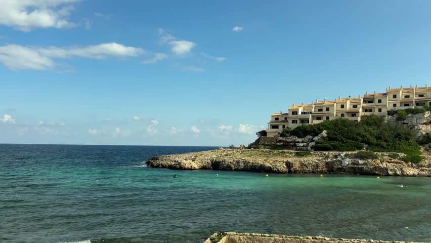 calm turquoise waters and seaside cliffs frame the serene landscape of cala murada on mallorca island spain