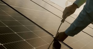 Worker fasten solar panels. Technician installing solar panels on metal stand. Technician working with electrical screwdriver installing solar panel to metal platform system. Installation solar panels - Powered by Shutterstock - Get 15% off with code: PIKWIZARD15