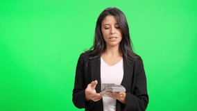Successful businesswoman counting money on green screen - Powered by Shutterstock - Get 15% off with code: PIKWIZARD15
