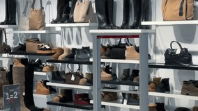 Winter Footwear and Handbags Display: Women's Boots and Shoes on Store Shelves | Modern Retail Shop Interior with Black Leather Boots, Beige Ankle Boots and Designer Bags | Fashion Boutique Shopping - Powered by Shutterstock - Get 15% off with code: PIKWIZARD15