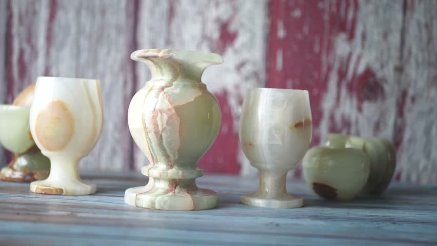 Unique handcrafted stone vases and cups displayed on a table