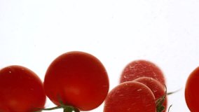 Close-up fresh red cherry tomatoes moving and splashing in water in slow motion - Powered by Shutterstock - Get 15% off with code: PIKWIZARD15