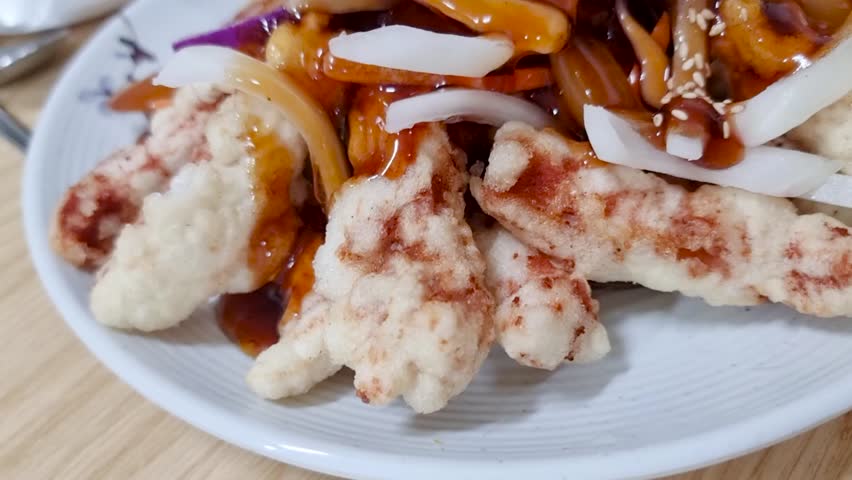 Crispy fried pork in sweet and sour sauce with vegetables