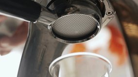 Close-up view of espresso machine portafilter as barista prepares rich coffee shot. Steam rises, highlighting the brewing process and artisan coffee culture. - Powered by Shutterstock - Get 15% off with code: PIKWIZARD15