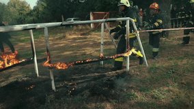 Firefighters in full gear run through a fiery obstacle course during intense training. Flames burst around as they demonstrate teamwork, bravery, and precision under extreme conditions. - Powered by Shutterstock - Get 15% off with code: PIKWIZARD15