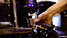 Barista expertly locks portafilter into espresso machine, preparing to brew rich, aromatic espresso in busy cafe environment. - Powered by Shutterstock - Get 15% off with code: PIKWIZARD15