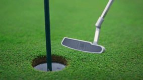 Close-up of putter making contact with golf ball near the hole on a vibrant green golf course. Perfect for sports enthusiasts looking for dynamic leisure visuals. - Powered by Shutterstock - Get 15% off with code: PIKWIZARD15