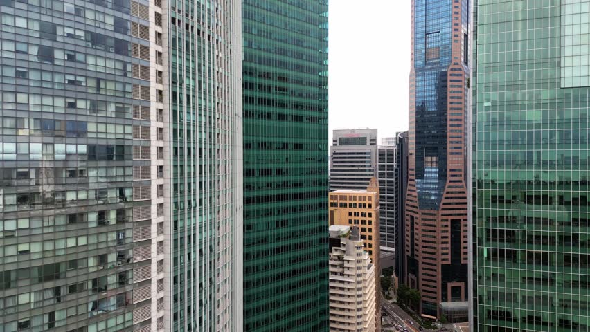 Aerial view of tall buildings with different colors and textures, showcasing the dense urban landscape, Singapore, Singapore.