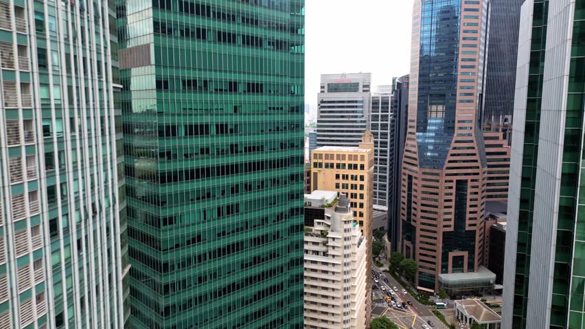 Aerial view of towering skyscrapers casting shadows on bustling streets, creating a mesmerizing urban landscape, Singapore, Singapore.