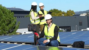 Diverse team of professional engineers installing and testing solar panels on a rooftop, collaborating on renewable energy production and sustainable green technology for a power plant - Powered by Shutterstock - Get 15% off with code: PIKWIZARD15