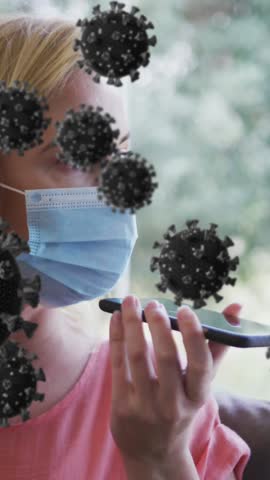 Christmas wreath over snow falling over multiple trees on winter landscape. Global covid pandemic concept digitally generated video.