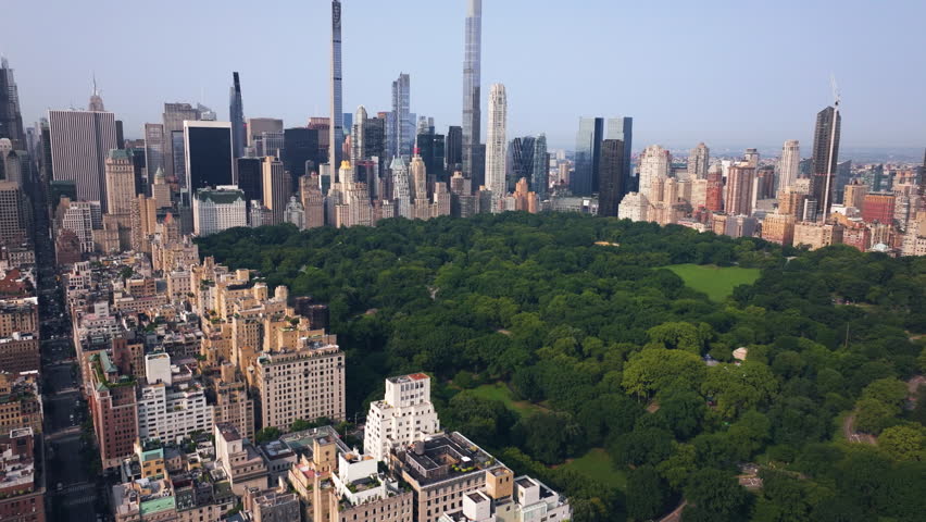 Drone tilting over Central park, toward the Billionaires row, golden hour in NYC