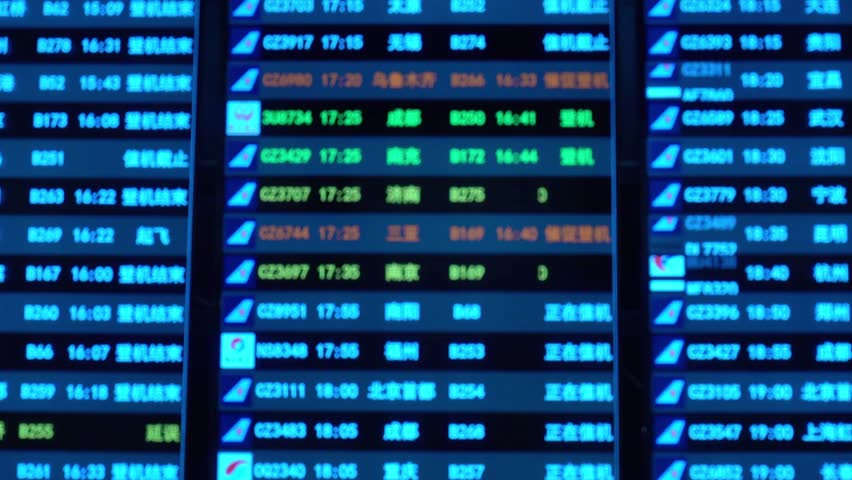 Airport departure and arrival information board displaying flight details in blue