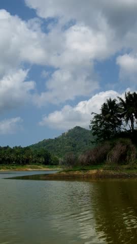 Vertical view of a lake with calm water during the day. Calm and peaceful atmosphere for relaxation. Ecological and environmental concept. 4K footage
