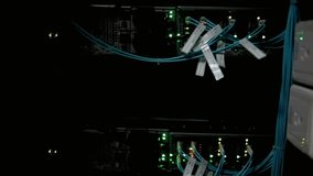 Data center servers with blinking lights and cables in a dark server room rack - Powered by Shutterstock - Get 15% off with code: PIKWIZARD15