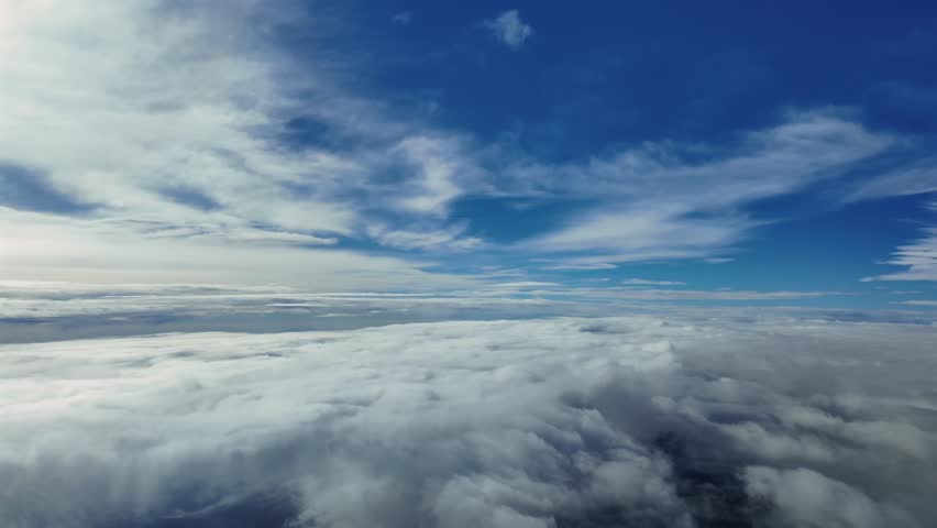 Supersonic flight experience from a jet cockit while flying through layers of ethereal clouds in a deep blue sky.