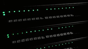 Server racks with green lights indicating network activity in a dark data center - Powered by Shutterstock - Get 15% off with code: PIKWIZARD15