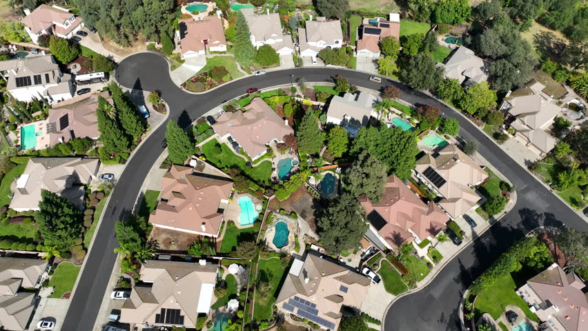 High angle drone shot circling above wealthy homes in Roseville,California