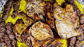 A platter of Arabic cuisine traditional food beef Kebab Kofta, kofta shish which is minced meat , oriental grilled barbecued meat food with long yellow rice and charcoal grilled barbecued chicken - Powered by Shutterstock - Get 15% off with code: PIKWIZARD15