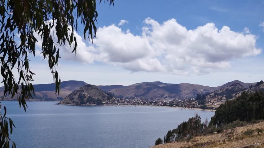 Titicaca lake landscape with mountains and blue sky on a sunny day in Bolivia