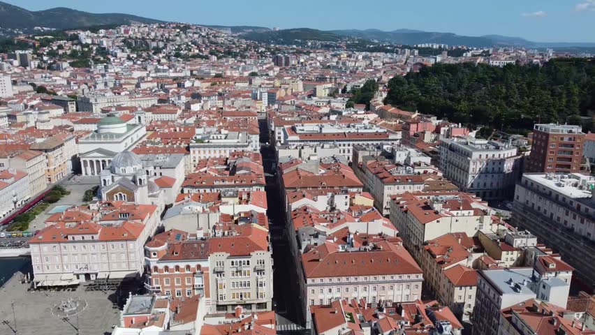 Aerial drone view of Trieste, Italy, showing the cityscape, waterfront, and historic buildings. Perfect for travel and urban projects.