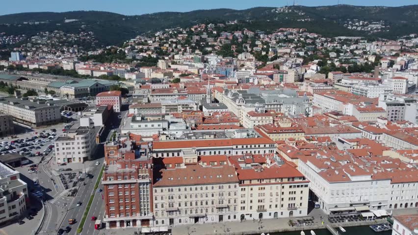 Aerial drone view of Trieste, Italy, showing the cityscape, waterfront, and historic buildings. Perfect for travel and urban projects.