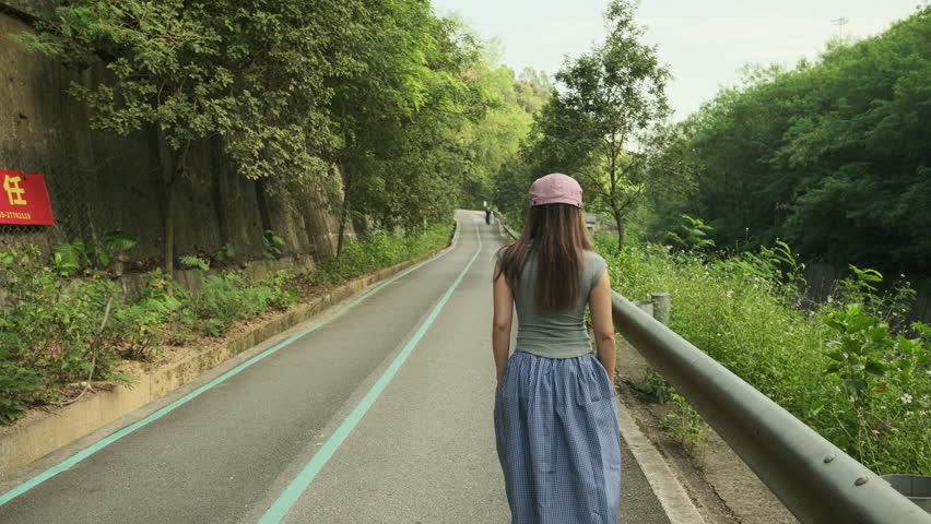 A Cinematic Shot of a Beautiful Woman Walking on a Park Path, Capturing a Quiet, Serene, and Relaxing Afternoon Moment (ProRes 422)