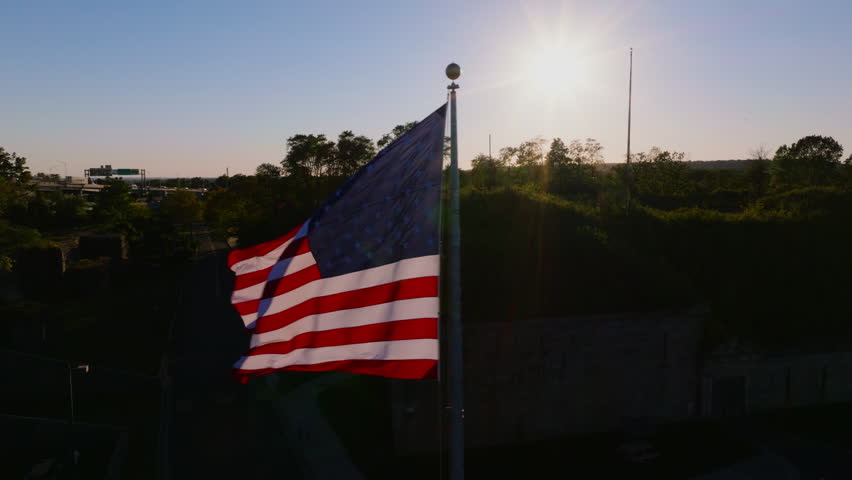 American flag waving near Battery Weed fort with the Verrazzano-Narrows Bridge in the background during sunset in Staten Island, New York, USA. ProRes HQ422. - Powered by Shutterstock - Get 15% off with code: PIKWIZARD15