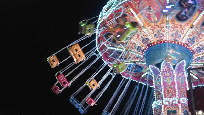 Colorful Spinning Carousel Ride at Night Amusement Park