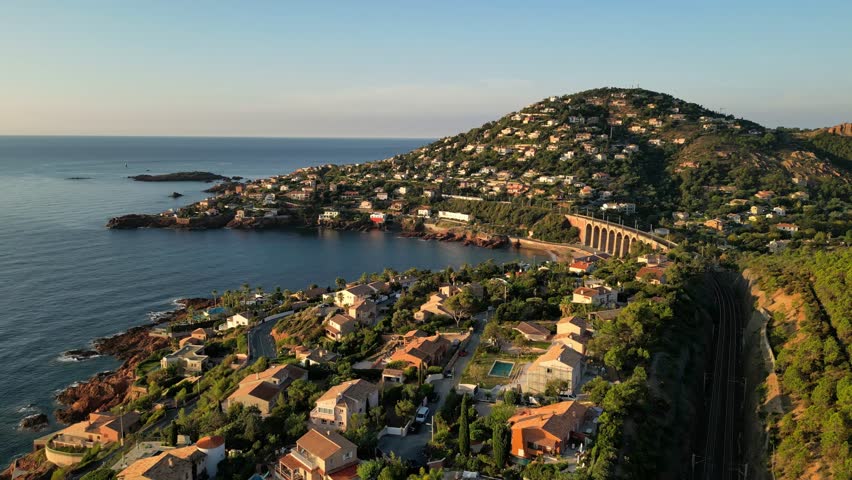 Aerial panoramic view of the Antheor Viaduct in the Esterel Mountains near Saint Raphael, French Riviera, overlooking the Mediterranean Sea and luxury villas along the Cote dAzur coastline at sunrise